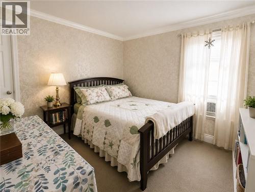 Textured wall covering paired with elegant crown molding adds warmth and character to the space. - 49 Palmerston Avenue, Brantford, ON - Indoor Photo Showing Bedroom