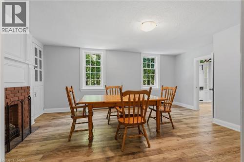 Dining area featuring wood-finish flooring and light gray walls - 41 Mill Street, Mississauga, ON - Indoor Photo Showing Dining Room With Fireplace