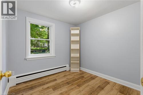 Light gray walls complement the wood-finish flooring - 41 Mill Street, Mississauga, ON - Indoor Photo Showing Other Room