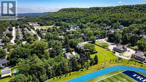 Residential area with mature trees, a blue track, and a football field - 21 Kerman Avenue, Grimsby, ON 