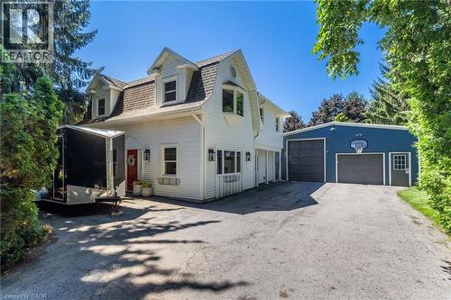 White siding exterior with a gambrel roof and dormer windows - 21 Kerman Avenue, Grimsby, ON 