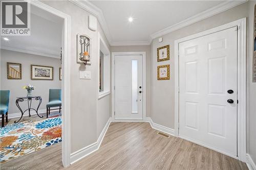 Entryway featuring light wood-finish flooring, white paneled doors with black hardware, recessed lighting, and crown molding - 5184 Red Brush Drive, Mississauga, ON - Indoor Photo Showing Other Room