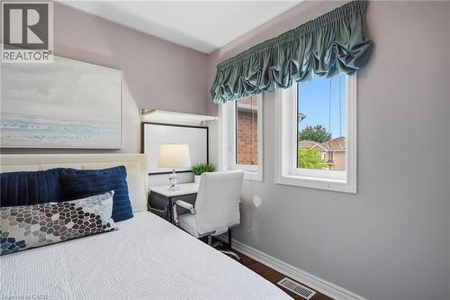 Room featuring light gray walls, white trim, and wood-finish flooring - 5184 Red Brush Drive, Mississauga, ON - Indoor Photo Showing Bedroom
