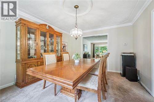 Recessed ceiling medallion with a chandelier, crown molding, and wall-to-wall carpeting - 119 Sandy Ridge Place, Waterloo, ON - Indoor Photo Showing Dining Room