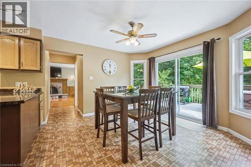 Dining area with patterned flooring, ceiling fan with integrated lighting, and direct access to an outdoor deck via sliding glass doors - 119 Sandy Ridge Place, Waterloo, ON - Indoor Photo Showing Dining Room
