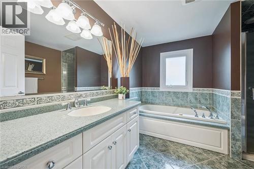 Double vanity with integrated sinks, light-toned countertop, and white cabinetry - 119 Sandy Ridge Place, Waterloo, ON - Indoor Photo Showing Bathroom
