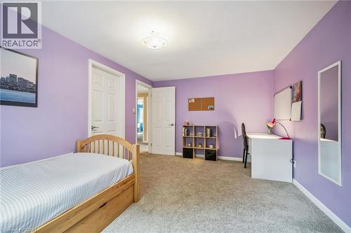 Plush carpet flooring, light purple wall paint, white trim, and a flush mount ceiling light fixture - 119 Sandy Ridge Place, Waterloo, ON - Indoor Photo Showing Bedroom