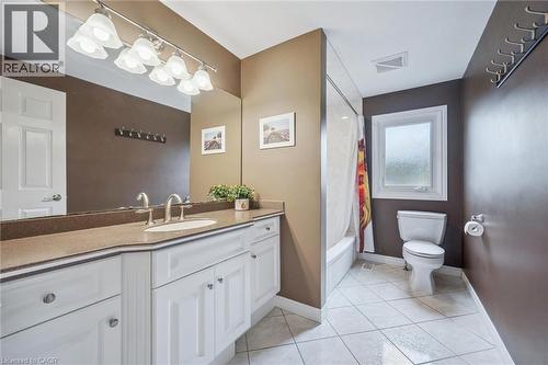 White shaker-style vanity with an integrated sink, brushed nickel faucet, and a large wall-mounted mirror - 119 Sandy Ridge Place, Waterloo, ON - Indoor Photo Showing Bathroom