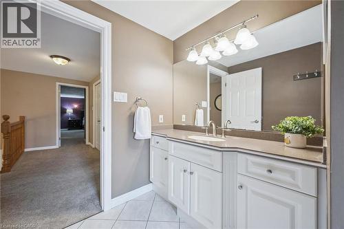White vanity with panel-front cabinetry, integrated sink, and stone-finish countertop - 119 Sandy Ridge Place, Waterloo, ON - Indoor Photo Showing Bathroom