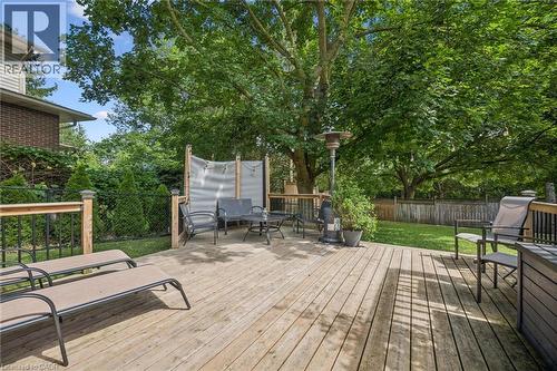 Expansive wood deck with a privacy screen, metal railing, and surrounding mature trees - 119 Sandy Ridge Place, Waterloo, ON - Outdoor With Deck Patio Veranda