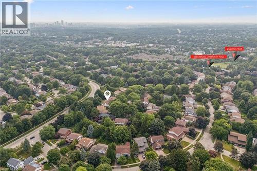 Aerial perspective of a verdant residential area featuring mature tree cover and varied architectural styles - 119 Sandy Ridge Place, Waterloo, ON - Outdoor With View
