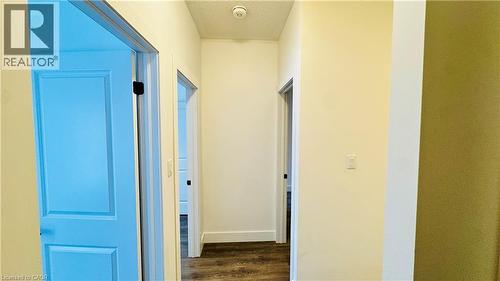 Hallway featuring wood-finish flooring, light-toned walls, recessed lighting, and panel doors - 1159 Lloyd Landing, Milton, ON - Indoor Photo Showing Other Room