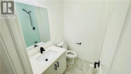 Bathroom featuring a vanity with an integrated sink, matte black faucet, and a large wall mirror - 1159 Lloyd Landing, Milton, ON - Indoor Photo Showing Bathroom