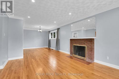 Living room open to dining room - 1227 Portland Avenue, Ottawa, ON - Indoor Photo Showing Living Room With Fireplace