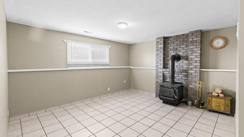 1643 Traut Court, Kelowna, BC - Indoor Photo Showing Other Room With Fireplace