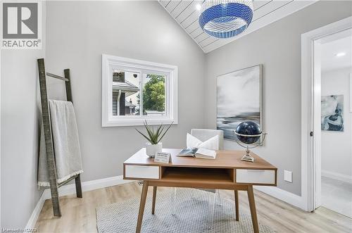Neutral-toned interior featuring a vaulted ceiling with wood-finish panels, a window with exterior views, and light wood-finish flooring - 10 Comet Avenue Unit# #1 (Main), Hamilton, ON - Indoor Photo Showing Office