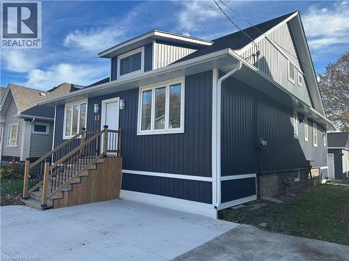 Contemporary residence featuring dark vertical siding with white trim - 10 Comet Avenue Unit# #1 (Main), Hamilton, ON - Outdoor With Exterior