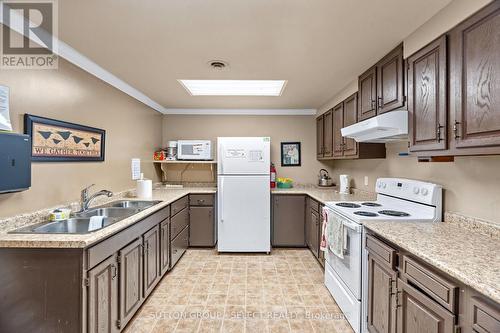 COMMUNITY CLUBHOUSE - 14 Devon Drive, South Huron (Exeter), ON - Indoor Photo Showing Kitchen With Double Sink