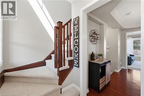 Staircase with carpeted treads and wood-tone railing - 171 Chase Crescent, Cambridge, ON - Indoor Photo Showing Other Room