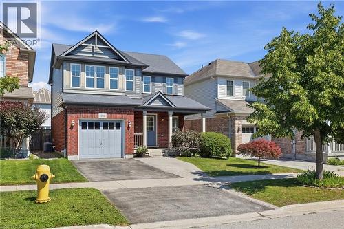 Two-story residence featuring brick and siding exterior, an attached single-car garage, and a covered front porch - 171 Chase Crescent, Cambridge, ON - Outdoor With Facade
