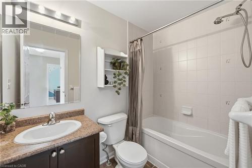 Vanity with integrated sink, stone-finish countertop, and dark wood-finish cabinetry - 171 Chase Crescent, Cambridge, ON - Indoor Photo Showing Bathroom