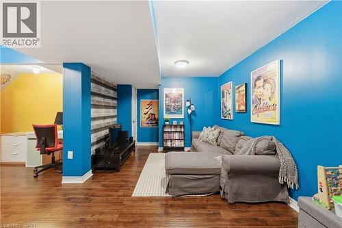 Hardwood-style flooring, recessed lighting, built-in shelving, white trim, and a partially visible built-in desk - 171 Chase Crescent, Cambridge, ON - Indoor Photo Showing Other Room