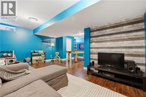 Wood-finish flooring throughout, featuring a stone-look accent wall - 171 Chase Crescent, Cambridge, ON - Indoor