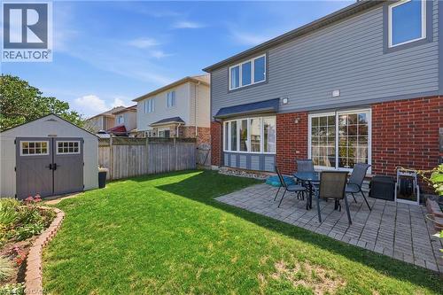 Expansive green space featuring a paved patio area, a bay window, and sliding glass doors - 171 Chase Crescent, Cambridge, ON - Outdoor