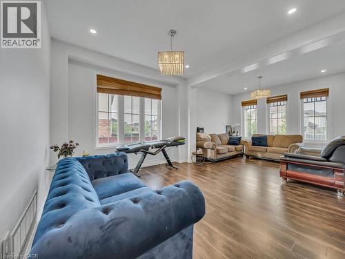 Recessed lighting, wood-finish flooring, multiple windows with blinds, and decorative light fixtures - 227 Baldwin Drive Unit# Main, Cambridge, ON - Indoor Photo Showing Living Room