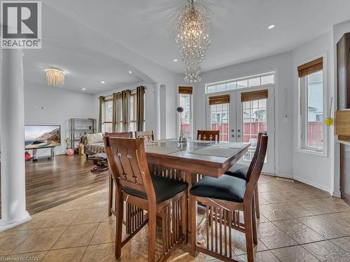 Two-story windows and patio doors, recessed lighting, and a crystal chandelier - 227 Baldwin Drive Unit# Main, Cambridge, ON - Indoor Photo Showing Dining Room