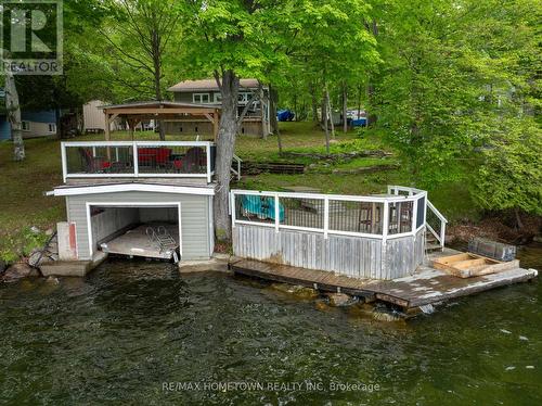 Single wet slip boathouse with plenty of mooring - 66 Scott Lane, Rideau Lakes, ON - Outdoor With Deck Patio Veranda