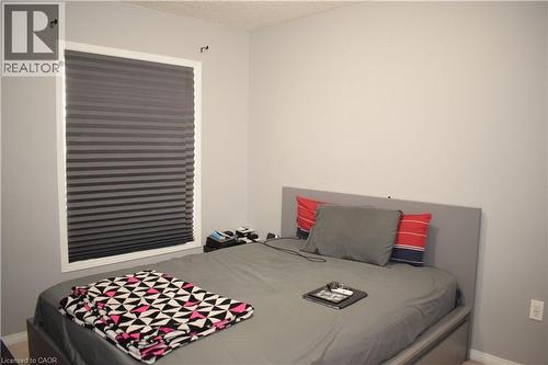 Neutral wall tones with a window featuring privacy blinds - 720 Brookmill Place, Waterloo, ON - Indoor Photo Showing Bedroom