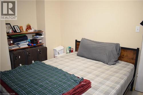 Built-in shelving with wood-finish shelves - 720 Brookmill Place, Waterloo, ON - Indoor Photo Showing Bedroom