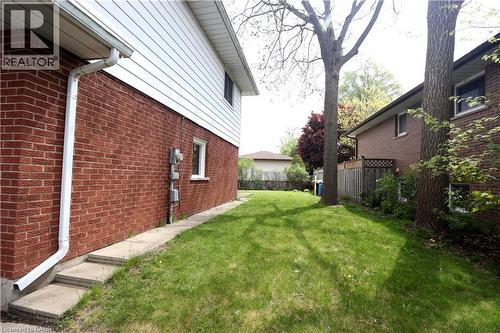 Brick and siding exterior with concrete walkway and steps - 77 Orchard Mill Crescent, Kitchener, ON - Outdoor With Exterior