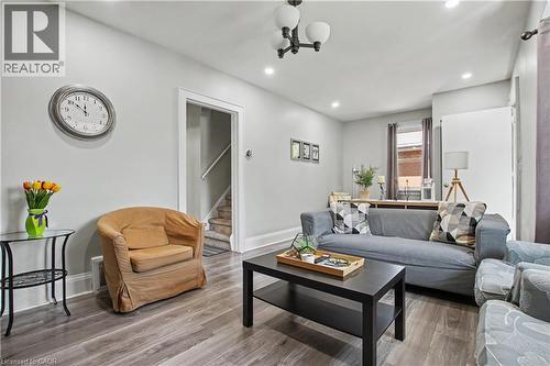 Wood-finish flooring throughout, recessed ceiling lighting, and a contemporary ceiling light fixture - 16 Mercer Road, Cambridge, ON - Indoor Photo Showing Living Room