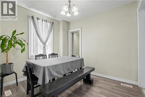 Recessed window, wood-finish flooring, brushed nickel chandelier, white trim, light neutral wall paint - 16 Mercer Road, Cambridge, ON - Indoor