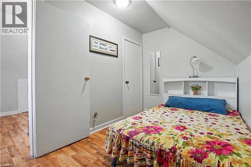 Sloped ceiling with recessed lighting, wood-finish flooring, and white interior doors - 16 Mercer Road, Cambridge, ON - Indoor Photo Showing Bedroom
