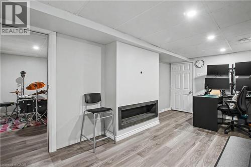 Recessed lighting, wood-finish flooring, white paneled door, and a built-in media niche - 16 Mercer Road, Cambridge, ON - Indoor Photo Showing Office
