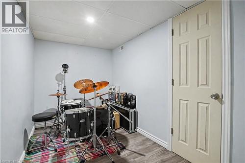 Recessed lighting, wood-finish flooring, white paneled door, drop ceiling - 16 Mercer Road, Cambridge, ON - Indoor Photo Showing Other Room
