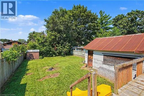 Expansive backyard featuring a manicured lawn, established perimeter fencing, and a detached storage shed - 16 Mercer Road, Cambridge, ON - Outdoor