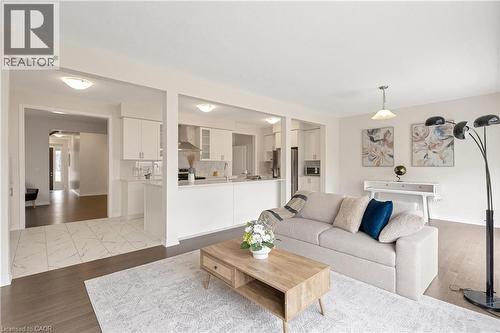 Open concept living area with dark wood-finish flooring, white wall paint, and recessed lighting - 285 Broadacre Drive, Kitchener, ON - Indoor Photo Showing Living Room