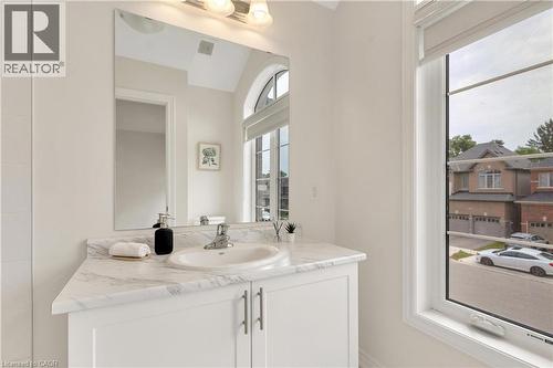 White vanity with a single basin sink, chrome faucet, and a marbled countertop - 285 Broadacre Drive, Kitchener, ON - Indoor Photo Showing Bathroom