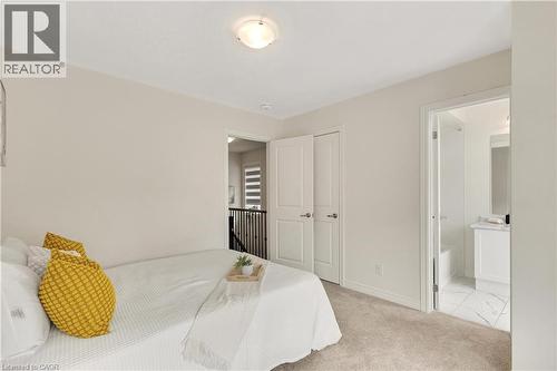 Neutral wall color, carpeted flooring, white trim, solid core doors, and a flush mount ceiling light - 285 Broadacre Drive, Kitchener, ON - Indoor Photo Showing Bedroom