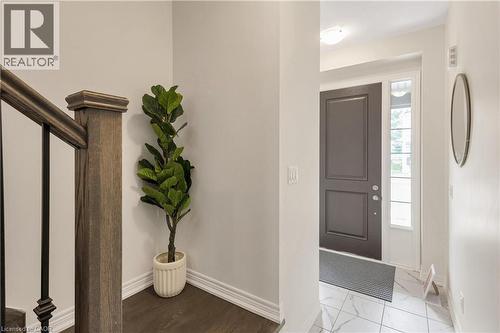 Entryway featuring a dark paneled door, sidelight window, and tile flooring - 285 Broadacre Drive, Kitchener, ON - Indoor Photo Showing Other Room