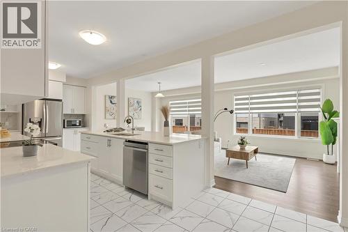 Kitchen featuring white cabinetry, light-toned countertops, stainless steel appliances, and tile flooring - 285 Broadacre Drive, Kitchener, ON - Indoor Photo Showing Kitchen With Stainless Steel Kitchen With Upgraded Kitchen