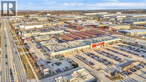 Expansive commercial complex with multiple retail units, ample surface parking, and direct frontage on a multi-lane thoroughfare - 589 Fairway Road S, Kitchener, ON 