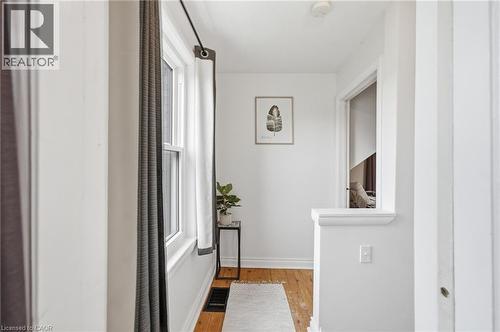 Upstairs Hallway featuring hardwood flooring, white painted walls, and a window - 481 Upper Gage Avenue, Hamilton, ON - Indoor Photo Showing Other Room