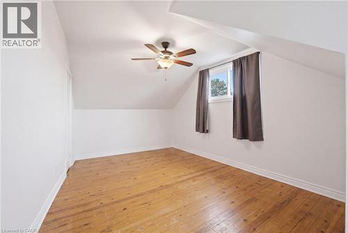Bedroom featuring hardwood flooring, white painted walls, and a ceiling fan with integrated lighting - 481 Upper Gage Avenue, Hamilton, ON - Indoor Photo Showing Other Room