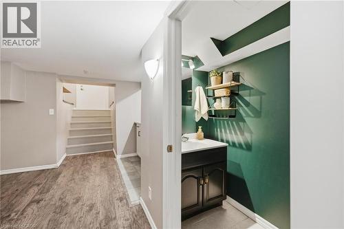 Basement bathroom off of kitchen featuring vanity with dark painted cabinetry - 481 Upper Gage Avenue, Hamilton, ON - Indoor
