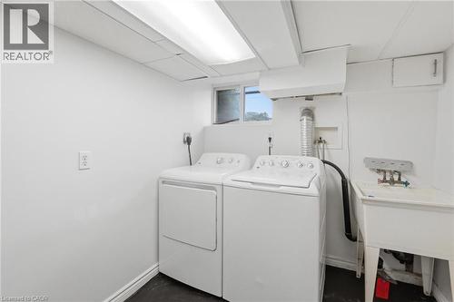 Dedicated laundry area featuring a utility sink, a window, and overhead fluorescent lighting - 481 Upper Gage Avenue, Hamilton, ON - Indoor Photo Showing Laundry Room